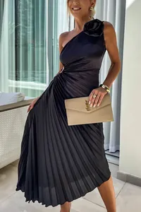 Detail showing black one-shoulder pleated evening dress with elegant floral accent