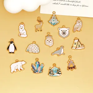 Various winter-themed enamel charms including polar bear and snowy scenes for DIY jewelry