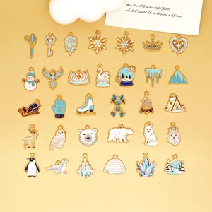 Assorted winter-themed enamel charms for DIY jewelry featuring snowflakes and animals.