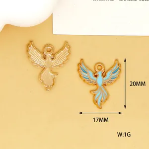 Detail view of gold phoenix charm with blue enamel showing 20mm x 17mm dimensions