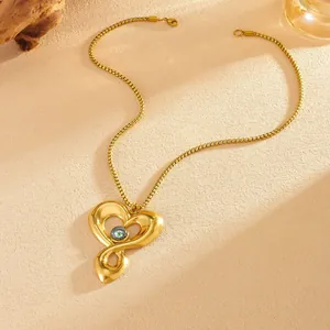 Detailed close-up of a heart-shaped evil eye pendant with gold PVD plated box chain.