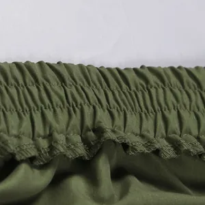 Close-up showing the elastic waistband detail of olive green cargo mini skirt fabric