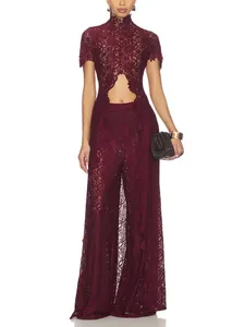 Elegant burgundy lace outfit detail featuring hollow-out top and wide-leg trousers.