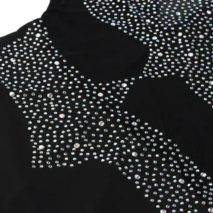 Primer plano de brillantes pedrería en un sexy vestido de malla negra ajustado.