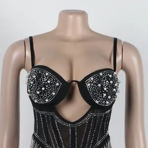 Close-up of black camisole dress with pearl and rhinestone bodice detail.