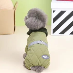 Detail view of green diamond quilted four-legged dog winter coat with fur collar.