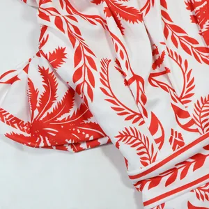 Gros plan sur le tissu à imprimé palmier tropical rouge et blanc pour combishort femme