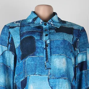 Detail view of a lapel collar slim dress with blue denim patchwork print pattern.
