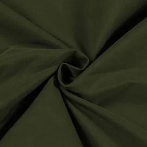Detailed macro view of dark olive green cargo fabric texture for women's workwear skirt.