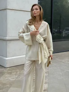 Elegant champagne tencel two-piece set featuring ruffle wrap top and wide leg pants