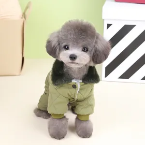 Warm green quilted four-legged dog winter coat with faux fur collar shown on a poodle.
