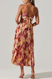 Detailed back view of a floral pleated maxi dress featuring a tie-back and criss-cross straps.