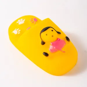 Detailed view of a yellow vinyl squeaky dog chew toy in slipper shape with cartoon girl