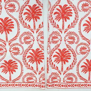 Vue détaillée du motif complexe de palmier tropical rouge sur tissu de combinaison blanc