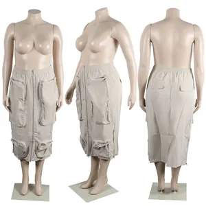 Detailed view of khaki utility midi skirt with multi-zipper pockets shown on mannequin.
