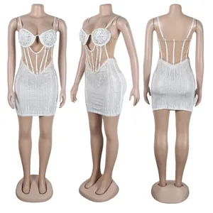 Detail view of a white mini dress with rhinestones and pearls from three angles.