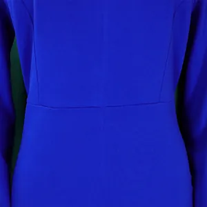 Detailed macro view showing the waist seam and knit texture of an elegant blue dress.