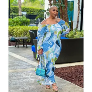 Full view of a woman wearing a blue floral off-the-shoulder maxi dress