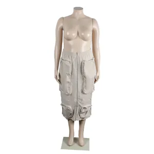 Detailed macro view of beige cargo midi skirt with multiple functional zipper pockets