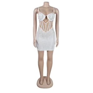 Stunning white bodycon mini dress with rhinestone and pearl detailing on a mannequin