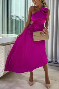 Detail view of a fuchsia one-shoulder pleated dress with waist cutout and floral accent