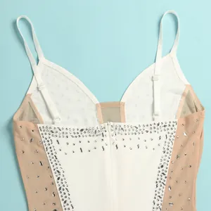 Close-up detail of white camisole evening dress with silver rhinestones and mesh.