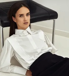 Elegant white cotton designer shirt with structured pleated details for women.