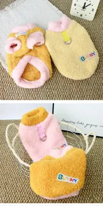 Soft plush pet sweater detail showing BUNNY patch and D-ring harness attachment.