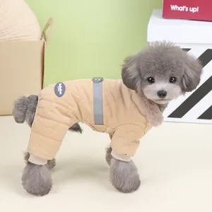 Close-up of a small dog wearing a beige diamond-quilted winter jumpsuit for pets.