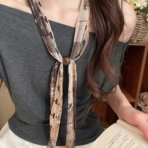 Elegant retro pleated print tie necklace for women worn by a model in a cozy lifestyle setting
