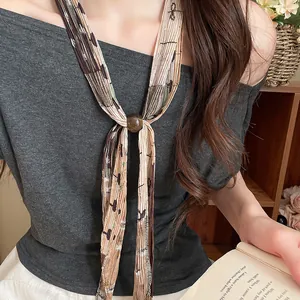 Detailed view of the retro pleated printed neck tie necklace with an elegant bead