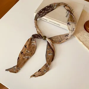 Close-up of vintage pleated printed necktie with decorative bead button detail.