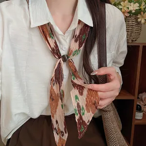 Close-up of artistic vintage pleated printed necktie necklace with decorative buckle