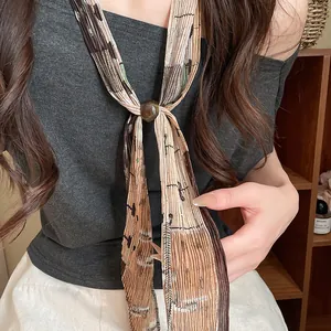 Close-up of retro pleated printed neck-tie necklace with artistic patterns