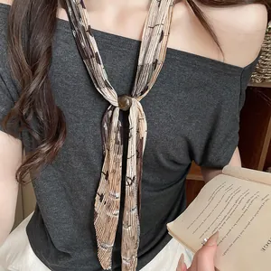 Detail shot of a vintage pleated floral neck scarf necklace with brown bead accent