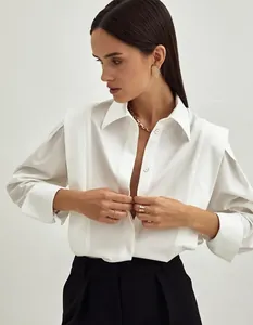Close-up detail showing structured shoulder pleats on white cotton French-style shirt