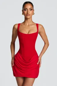 Close-up of red sleeveless low-neck bodycon mini dress with draped skirt detail