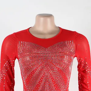 Close-up view of intricate silver rhinestone patterns on a red long-sleeved evening dress
