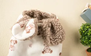 Close-up detail of soft bear pattern dog vest featuring a warm brown fleece lining