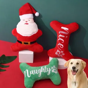 Christmas squeaky dog toys set including Santa and plush bones with Nice and Naughty text