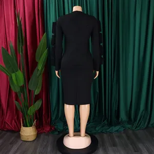 Elegant plus size black long sleeve midi dress with ruffle sleeve detail back view.