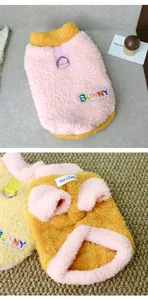 Close-up detail of thick warm pink and yellow fleece pet sweater with BUNNY embroidery patch