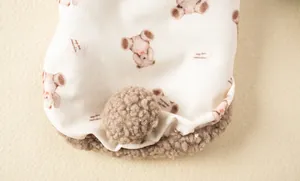 Detailed view of soft pet vest featuring cute bear patterns and a brown pom-pom