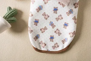 Macro view of pet vest with cute bear and blue polka dot print on ribbed fabric.
