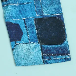 Close-up detail of blue patchwork denim print pattern on a slim fitted evening dress.