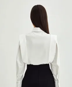 Back view detail of a white cotton French style shirt with unique shoulder design.