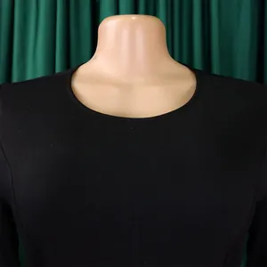 Detail shot of a black minimalist round neck long sleeve dress on a mannequin bust.