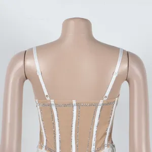 Back view detail of a nude rhinestone embellished camisole dress on a mannequin