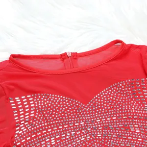 Close-up of red mesh evening gown featuring intricate silver rhinestone embellishments