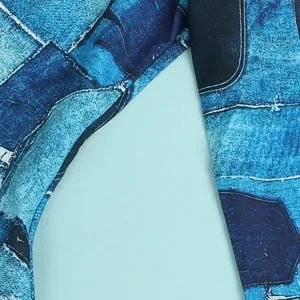 Close-up of blue distressed denim patchwork print on slim-fit nightclub dress